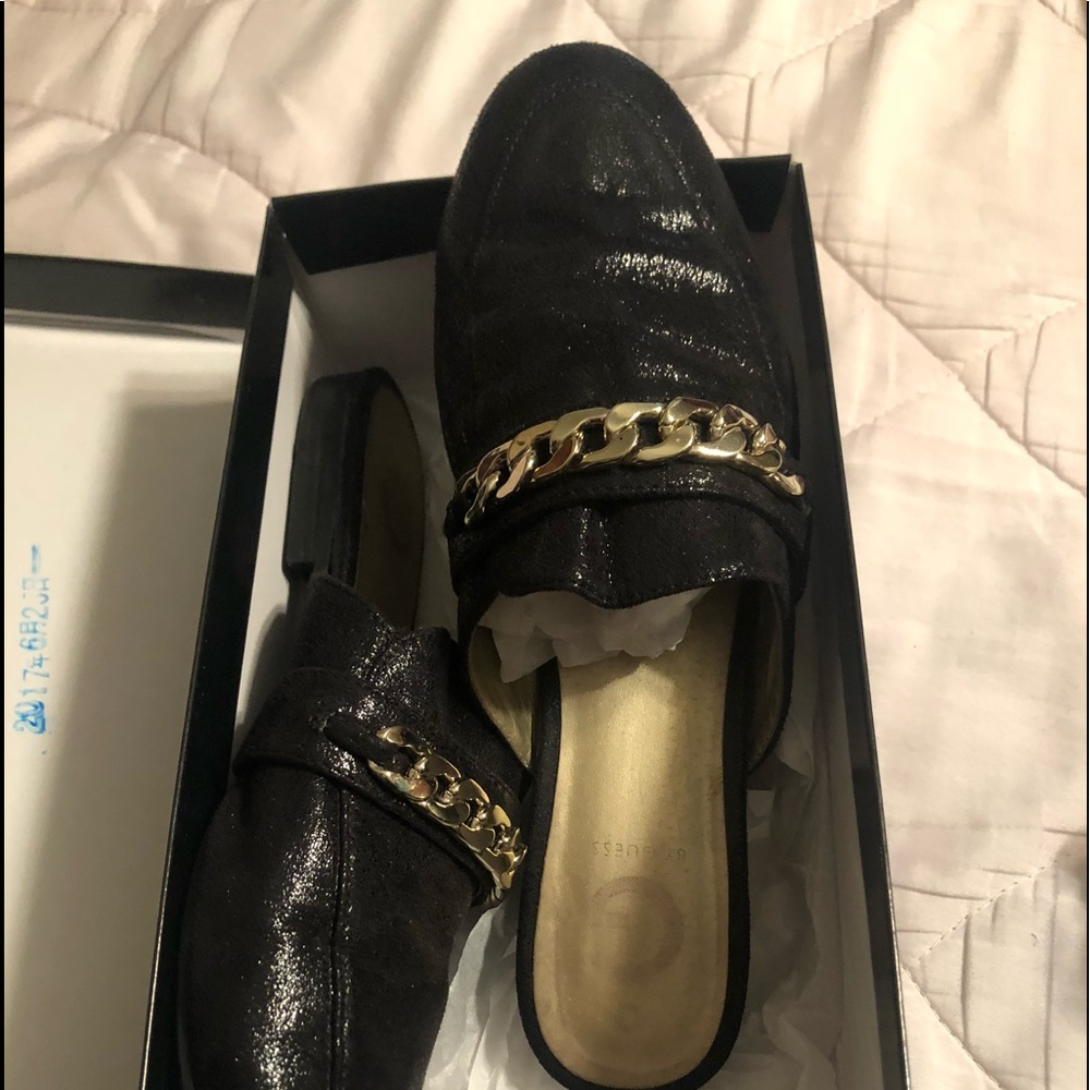 Black leather mules with silver chain accent